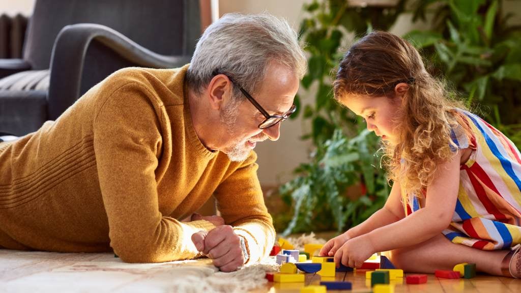 Grandad playing leggo with granddaughter 