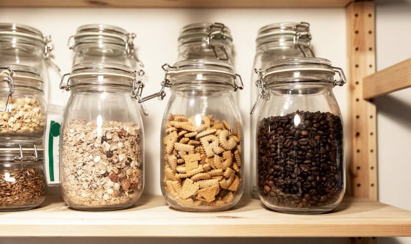Re-useable glass containers filled with dry pantry goods.