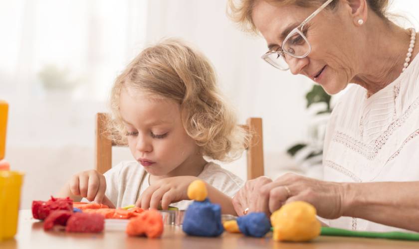 granddaughter and grandmother playing with playdough 