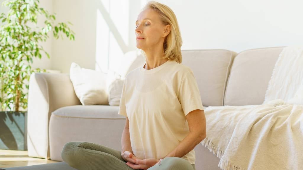 Woman relaxes by taking deep breaths
