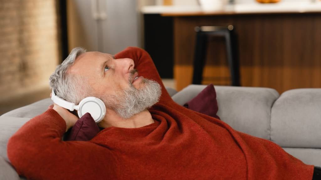 Man relaxing listening to podcast 
