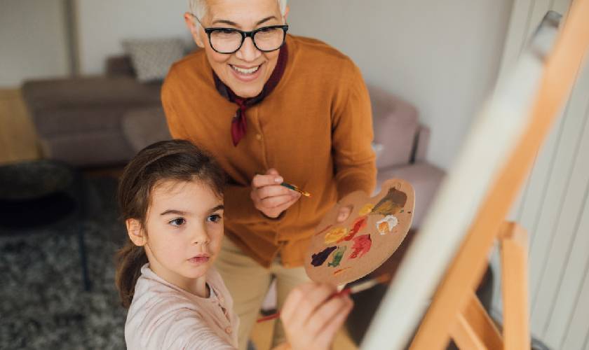 grandmother and grandkids painting together