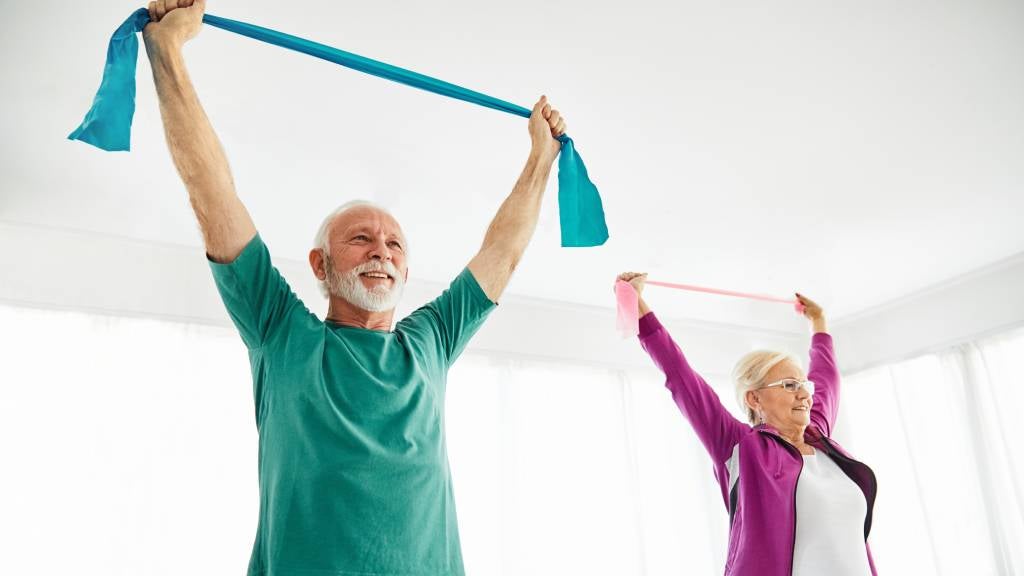 Couple engage in mobility exercise at home