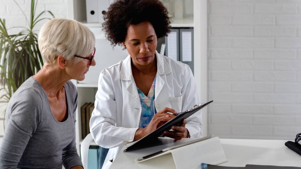 older woman discussing medical results with doctor