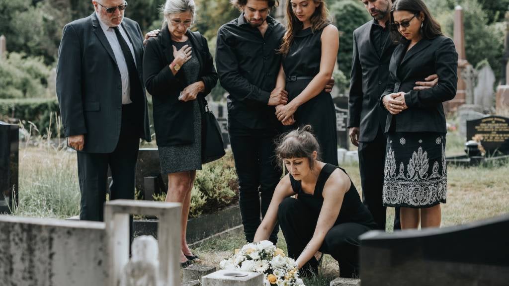 Family laying flowers on a grave