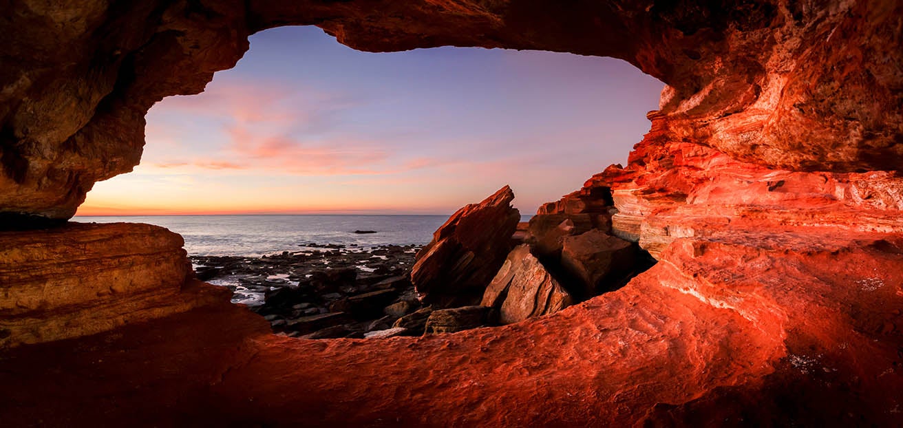 Ocean cave overlooking sunset