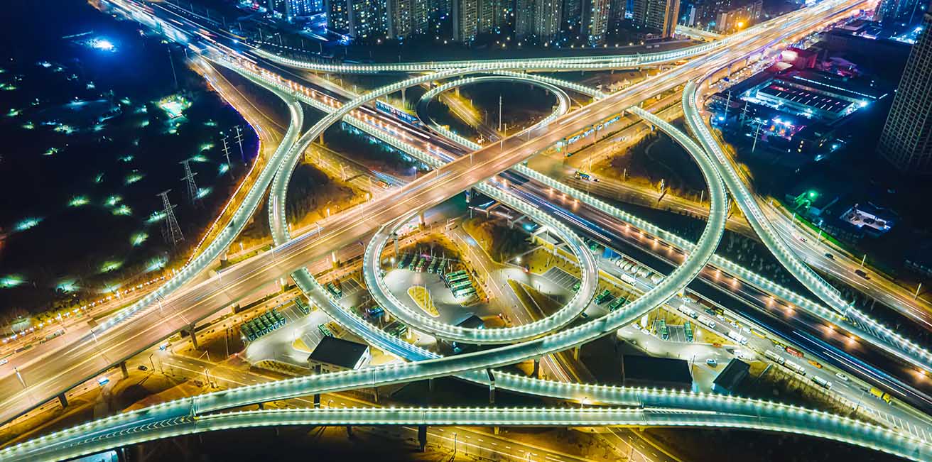 Busy tollroads and roundabout at night