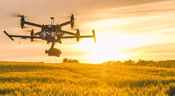 Drone over field at sunset