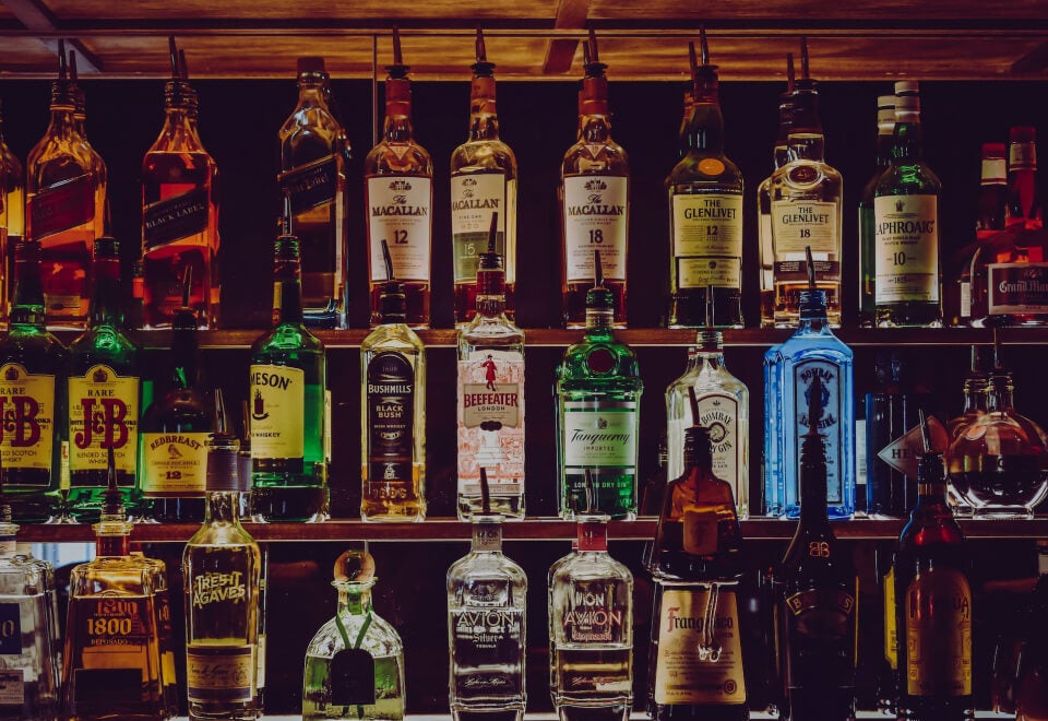 Spirits Platform | Bottles of spirits shown on three shelves in a bar | Devotion