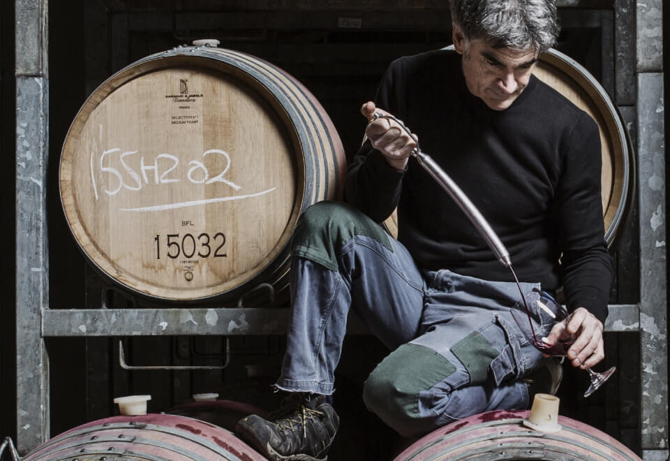 Wine Australia | man kneeling on a wine barrel pouring wine into a glass | Devotion