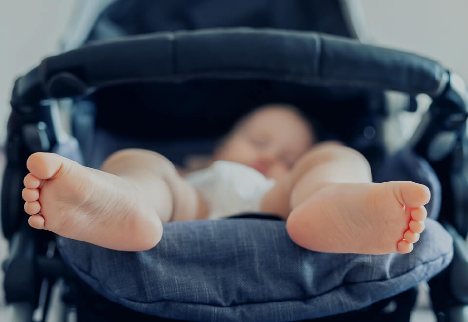 Baby Village | baby lying in pram | Devotion