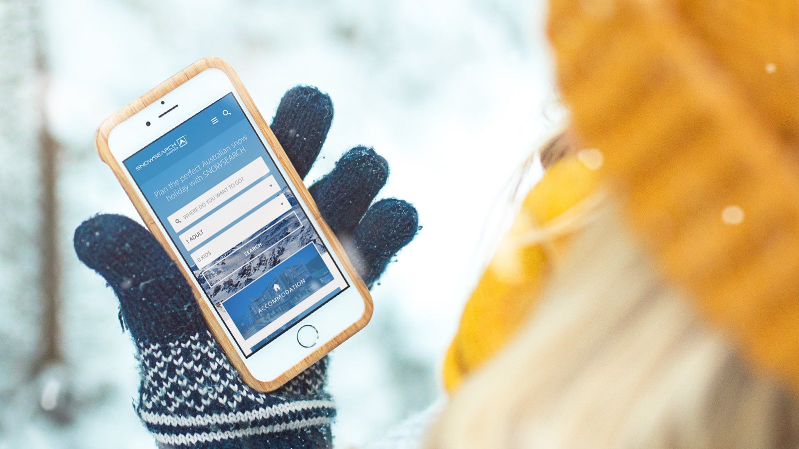 Snowsearch | website on mobile held by someone in the snow wearing a glove | Devotion